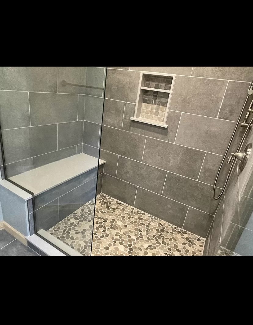 Walk-in shower with built-in bench and pebble floor